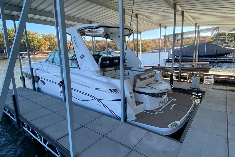 Slide: The Image of 2017 Monterey 355 Sport Yacht docked at a marina with scenic lake view. - 2