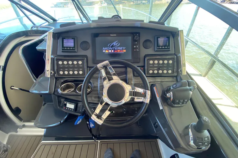 Slide: The Image of Cockpit of 2017 Monterey 355 Sport Yacht with advanced navigation controls and steering wheel. - 21