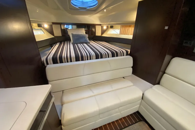 Slide: The Image of Luxurious interior of 2017 Monterey 355 Sport Yacht with striped bedding and white seating. - 32