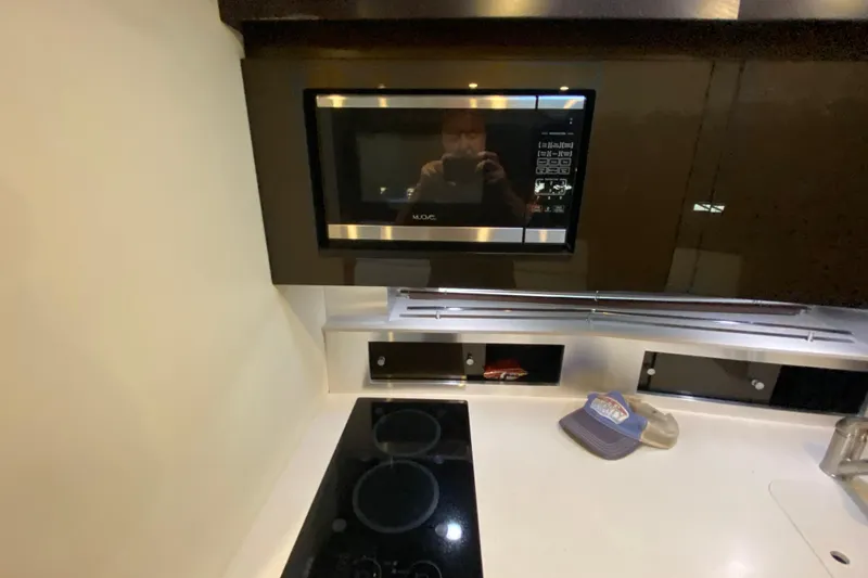 Slide: The Image of Modern kitchen in 2017 Monterey 355 Sport Yacht with microwave and stovetop. - 39