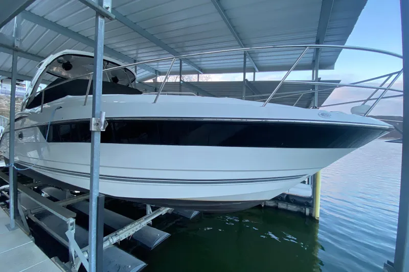 Slide: The Image of 2017 Monterey 355 Sport Yacht docked under a covered marina. - 57