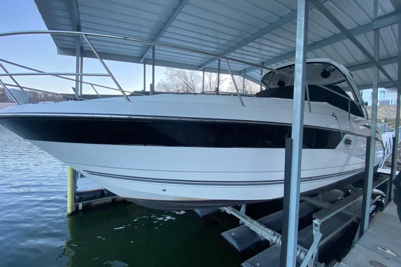 Slide: The Image of 2017 Monterey 355 Sport Yacht docked under a covered marina. - 58