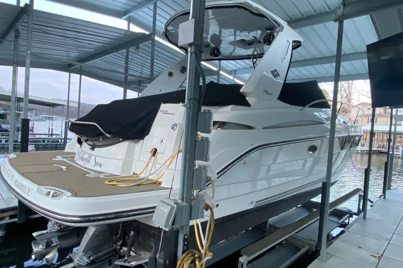 Slide: The Image of 2017 Monterey 355 Sport Yacht docked under a covered marina. - 59