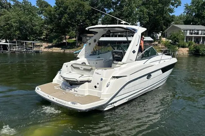 Slide: The Image of 2017 Monterey 355 Sport Yacht cruising on a serene lake with lush greenery. - 62