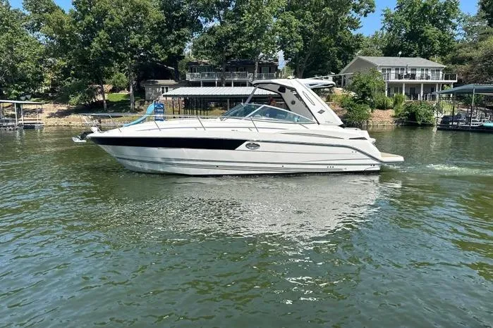 Slide: The Image of 2017 Monterey 355 Sport Yacht cruising on a serene lake with lush greenery. - 64