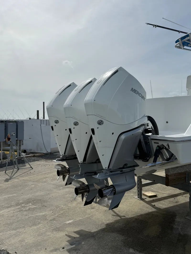 Slide: The Image of Three Mercury outboard engines on a 2021 Onslow Bay 33TE boat. - 7