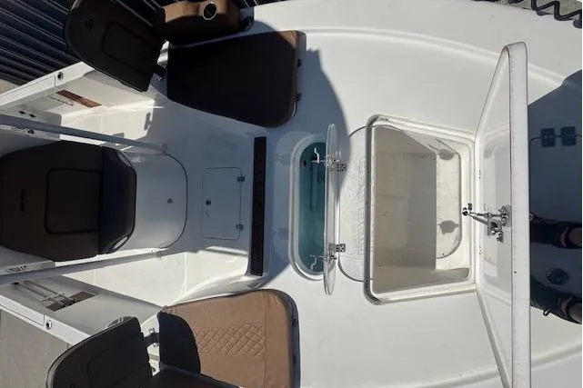 Slide: The Image of 2022 Sea Pro 248 Bay boat interior with seating and storage compartments. - 8