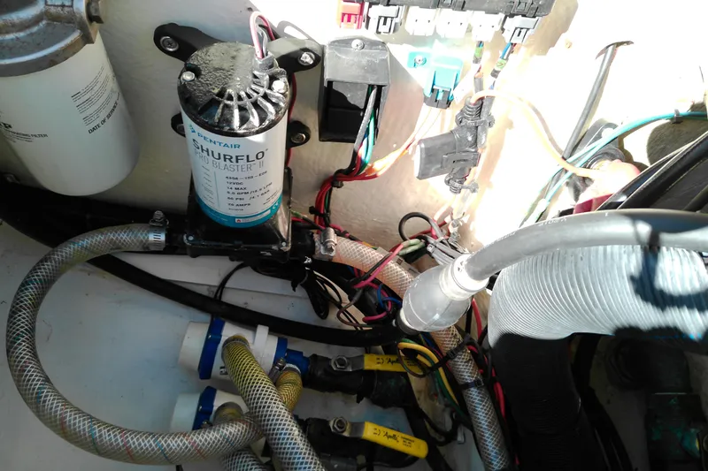 Slide: The Image of Boat engine compartment with wiring and Shurflo pump, Pathfinder 2200 T, 2016 model. - 13
