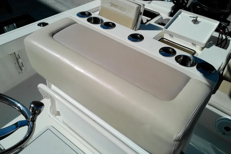 Slide: The Image of 2016 Pathfinder 2200 T boat interior with cup holders and steering wheel. - 16