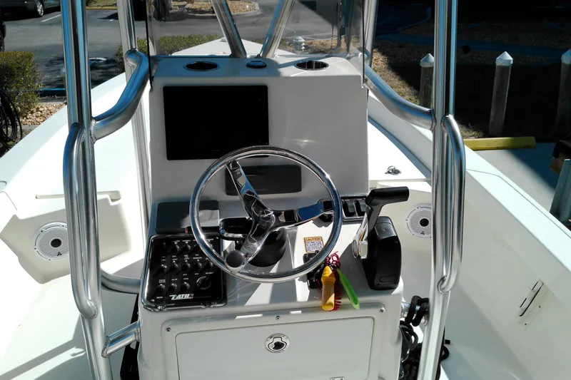 Slide: The Image of 2016 Pathfinder 2200 T boat console with steering wheel and controls. - 17