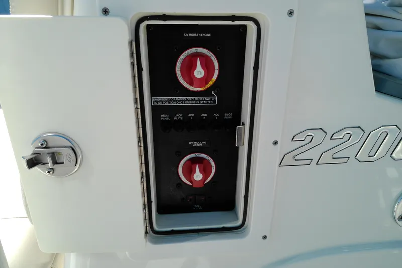 Slide: The Image of Control panel on a 2016 Pathfinder 2200 T boat, featuring switches and dials. - 22