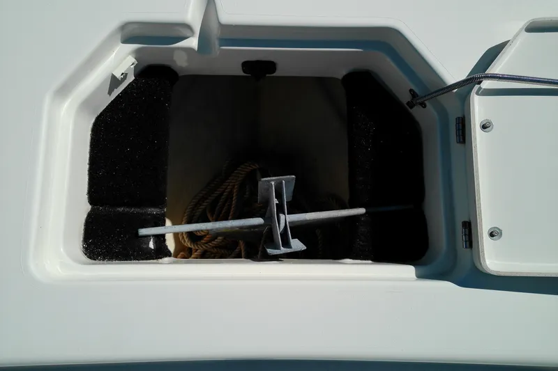 Slide: The Image of Anchor storage compartment on 2016 Pathfinder 2200 T boat, featuring rope and anchor. - 24