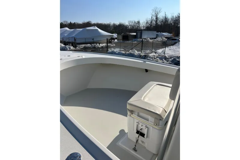 Slide: The Image of 2015 Parker 21SE Center Console boat interior with seating, parked outdoors in winter. - 11