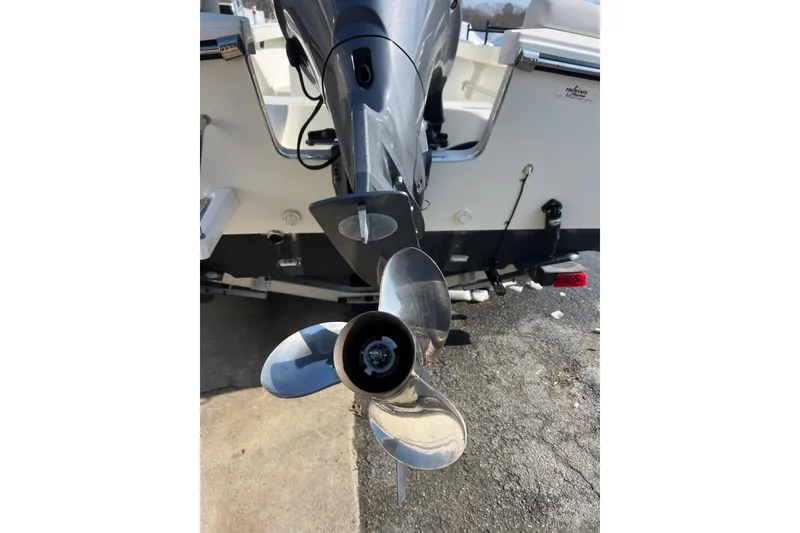 Slide: The Image of 2015 Parker 21SE Center Console boat with shiny propeller and motor detail. - 14