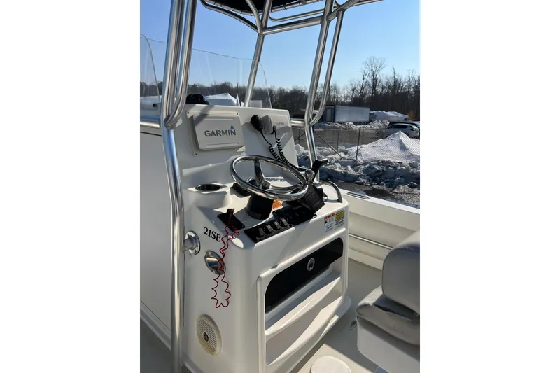 Slide: The Image of 2015 Parker 21SE Center Console boat with Garmin navigation system, steering wheel, and controls. - 6