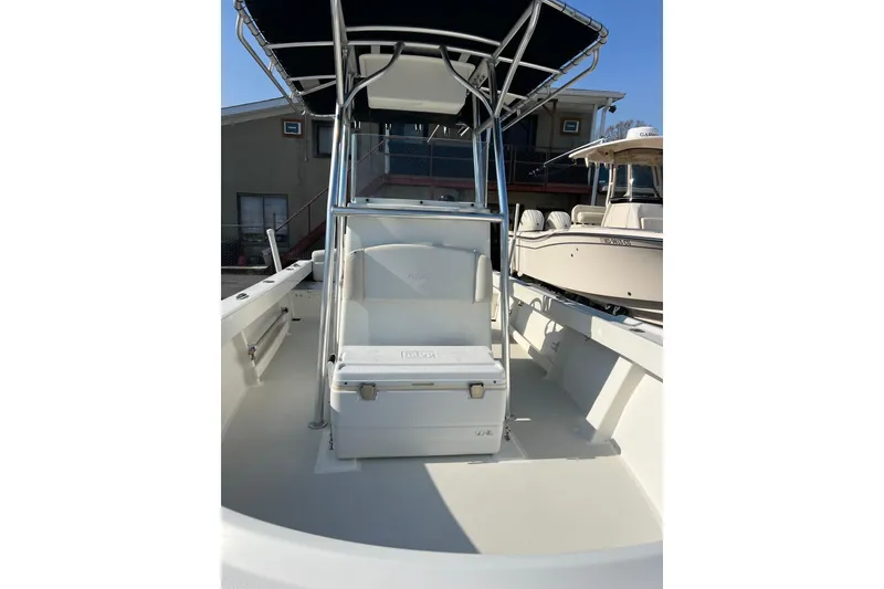 Slide: The Image of 2015 Parker 21SE Center Console boat with T-top and seating, docked outdoors. - 7