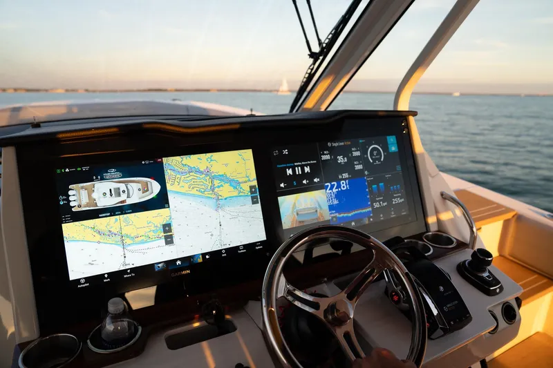 Slide: The Image of Cockpit of 2025 Regal 38 SAV boat with advanced navigation displays and steering wheel. - 10