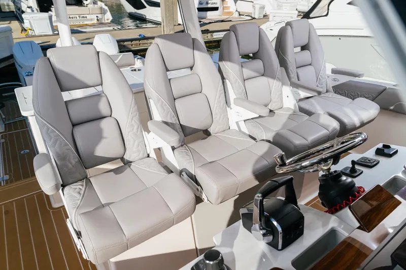Slide: The Image of Luxurious seating on 2025 Regal 38 SAV boat, featuring modern helm controls. - 12