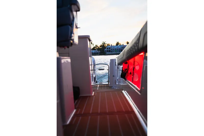 Slide: The Image of 2025 Regal 38 SAV boat interior with sunset view over water. - 13