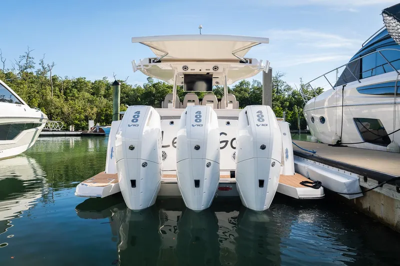 Slide: The Image of 2025 Regal 38 SAV boat with triple 400 V10 engines docked at marina. - 15