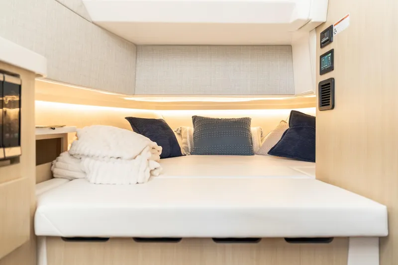 Slide: The Image of Luxurious cabin interior of 2025 Regal 38 SAV yacht with cozy bedding and ambient lighting. - 24
