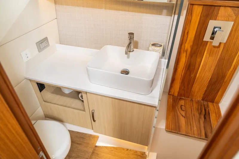 Slide: The Image of Luxurious bathroom interior of 2025 Regal 38 SAV yacht with modern sink and wooden accents. - 25