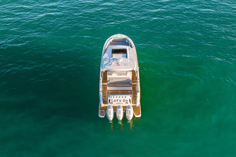 Slide: The Image of Aerial view of 2025 Regal 38 SAV boat on clear turquoise water. - 26