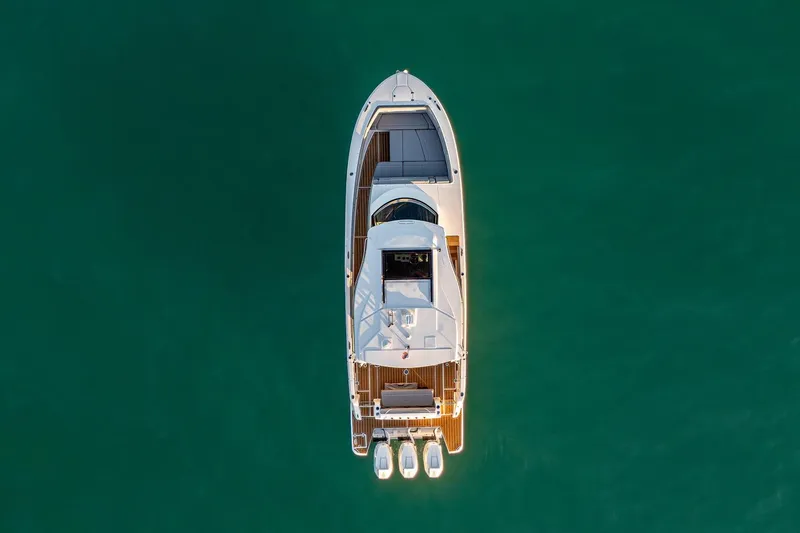 Slide: The Image of Aerial view of 2025 Regal 38 SAV yacht on calm green water. - 28