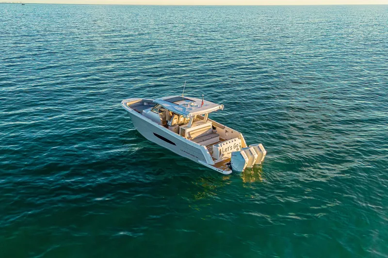 Slide: The Image of 2025 Regal 38 SAV boat cruising on open water, showcasing sleek design and powerful engines. - 29