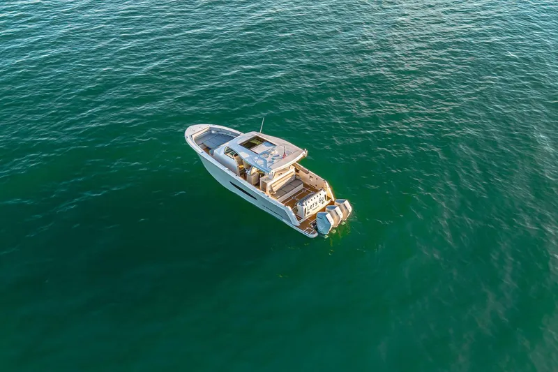 Slide: The Image of Aerial view of 2025 Regal 38 SAV boat on calm ocean waters. - 30