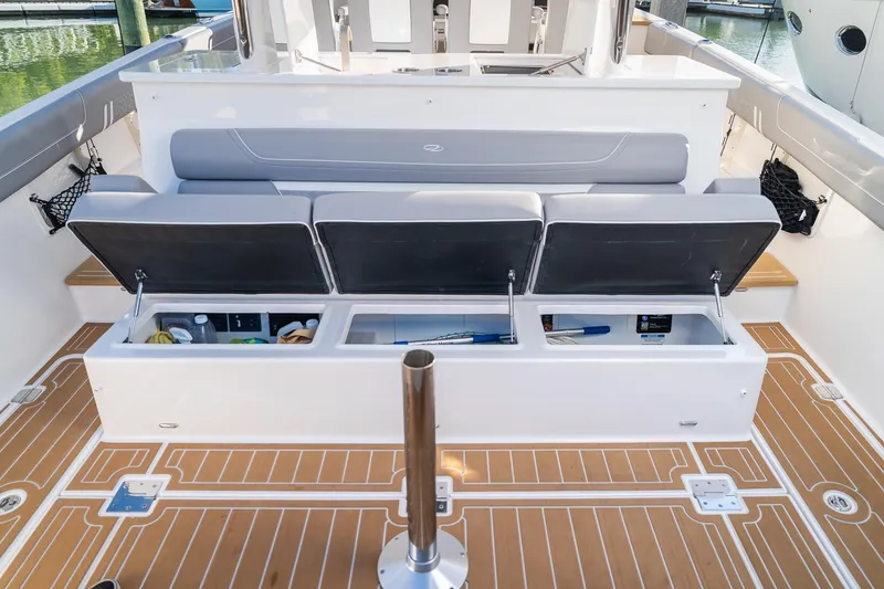 Slide: The Image of 2025 Regal 38 SAV boat with open storage compartments on deck. - 6