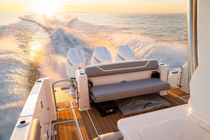 Slide: The Image of 2025 Regal 38 SAV boat cruising at sunset with powerful engines and sleek design. - 8