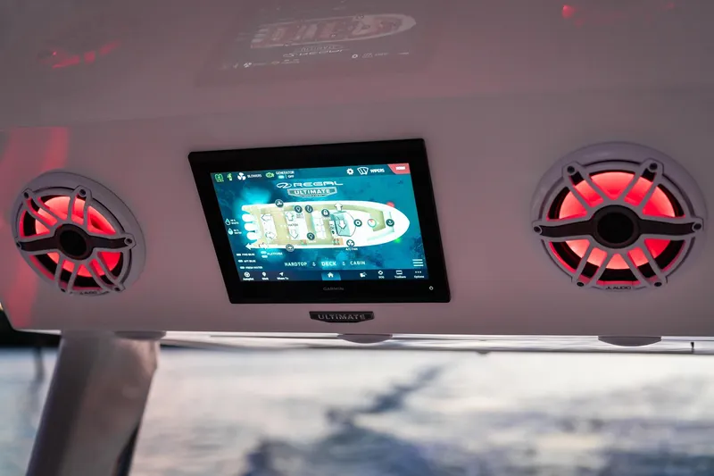 Slide: The Image of Control panel and speakers on a 2025 Regal 38 SAV boat, featuring illuminated display. - 9