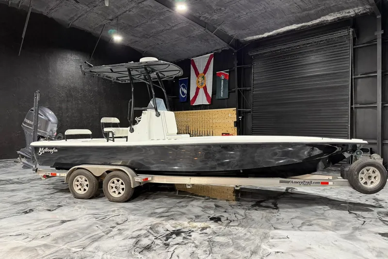 Slide: The Image of 2011 Yellowfin 24 Bay boat on trailer in indoor storage facility. - 1