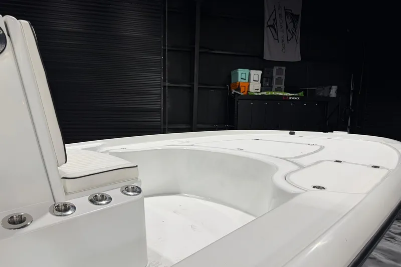 Slide: The Image of 2011 Yellowfin 24 Bay boat interior with seating and storage compartments. - 13