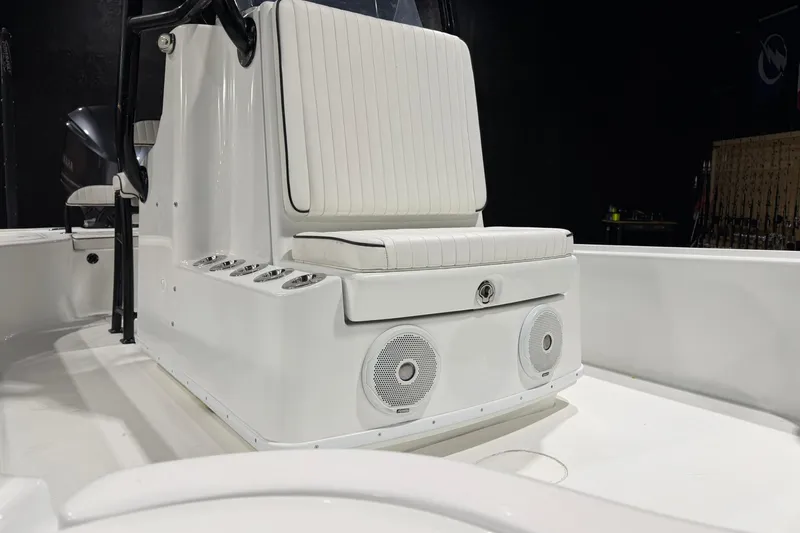Slide: The Image of 2011 Yellowfin 24 Bay boat interior with white seating and built-in speakers. - 15