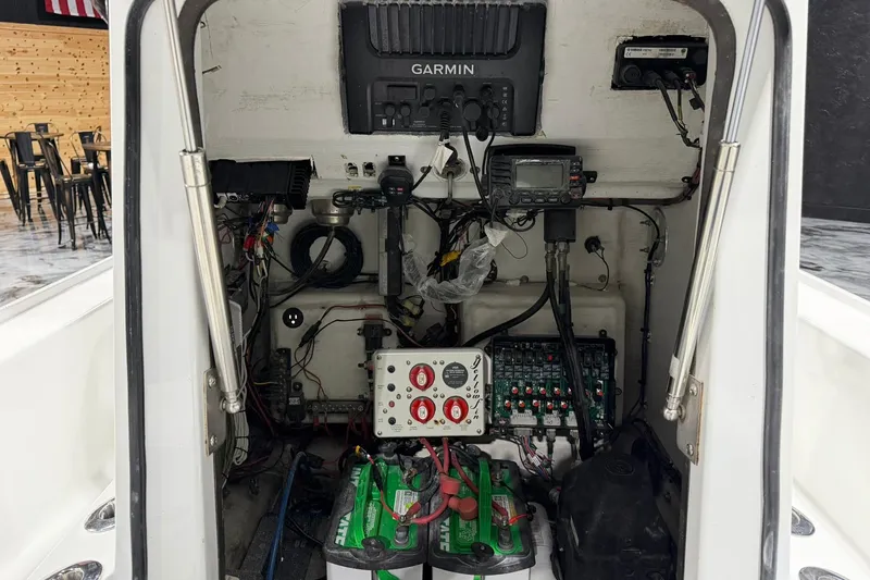Slide: The Image of 2011 Yellowfin 24 Bay boat electronics and wiring compartment with Garmin equipment. - 19