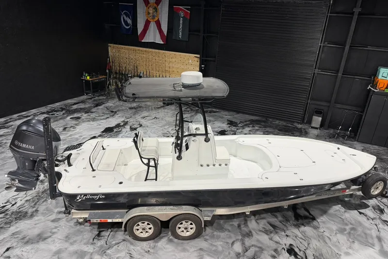 Slide: The Image of 2011 Yellowfin 24 Bay boat on trailer in a garage with Yamaha engine. - 21