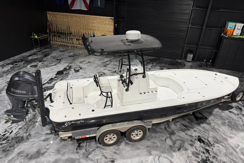 Slide: The Image of 2011 Yellowfin 24 Bay boat with Yamaha engine on trailer in showroom. - 22