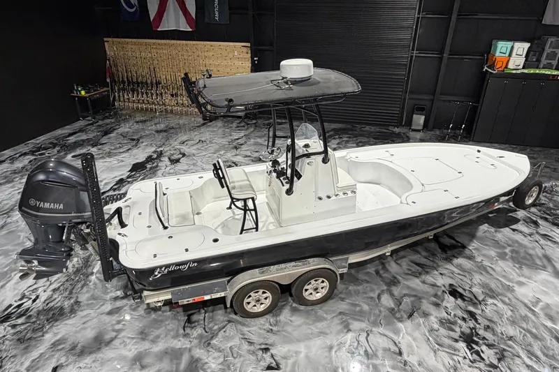 Slide: The Image of 2011 Yellowfin 24 Bay boat with Yamaha engine on trailer in showroom. - 23
