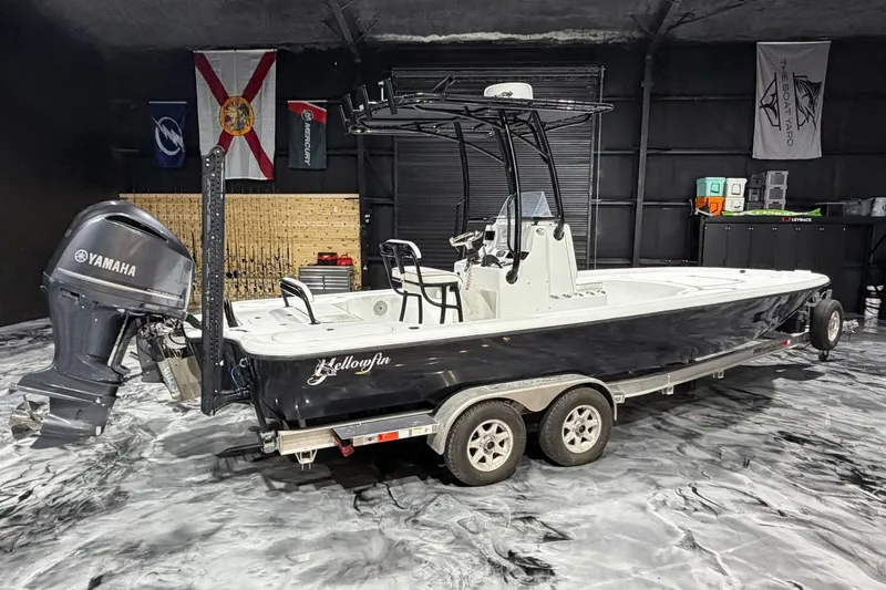 Slide: The Image of 2011 Yellowfin 24 Bay boat with Yamaha engine in a garage setting. - 24