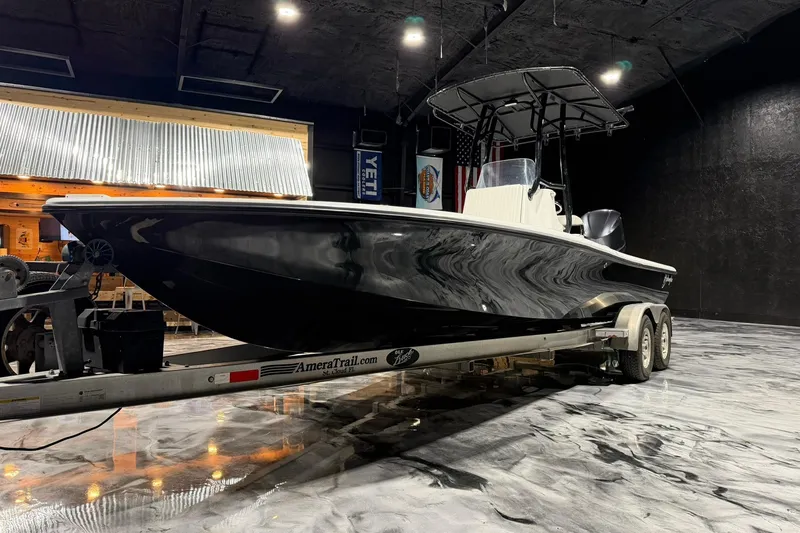 Slide: The Image of 2011 Yellowfin 24 Bay boat on trailer in indoor showroom setting. - 4