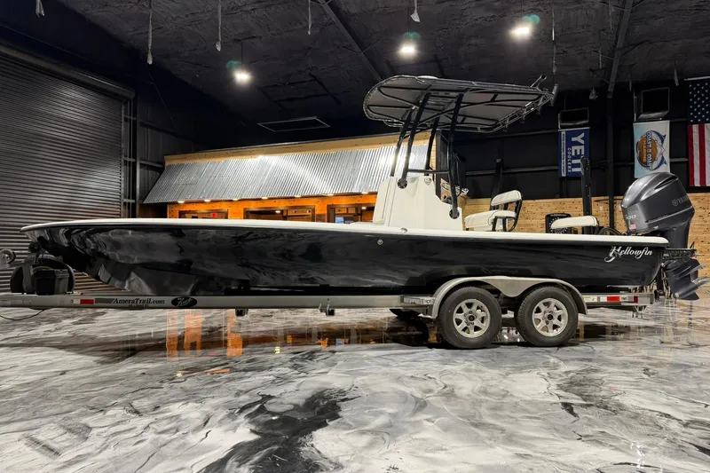 Slide: The Image of 2011 Yellowfin 24 Bay boat on trailer in indoor showroom setting. - 5