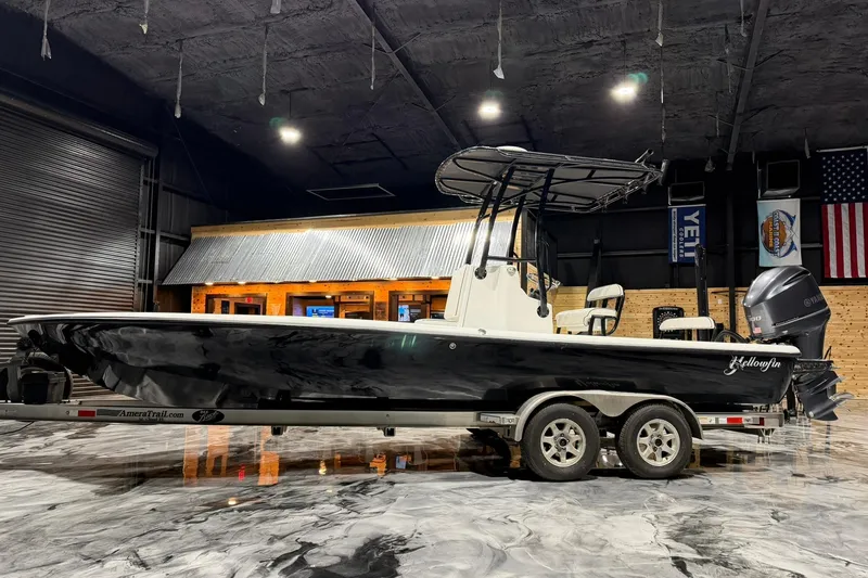Slide: The Image of 2011 Yellowfin 24 Bay boat on trailer in indoor showroom setting. - 6