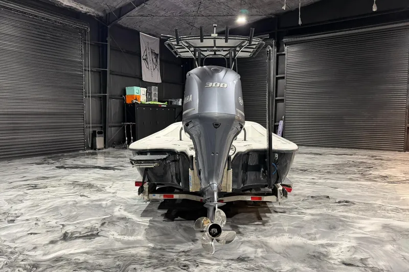 Slide: The Image of 2011 Yellowfin 24 Bay boat with Yamaha 300 engine in a garage. - 9