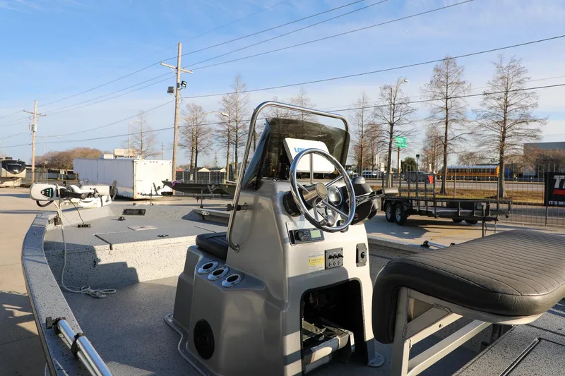 Slide: The Image of 2019 Express 18 boat with steering console, parked outdoors under clear sky. - 11
