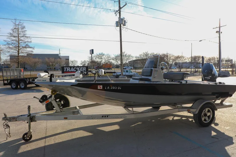 Slide: The Image of 2019 Express 18 boat on trailer in parking lot, sunny day. - 12