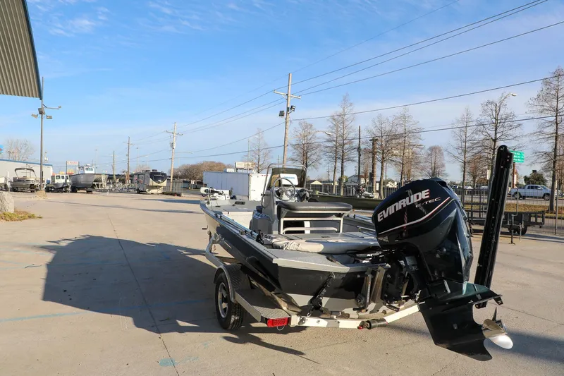 Slide: The Image of 2019 Express 18 boat with Evinrude motor parked outdoors on a sunny day. - 5