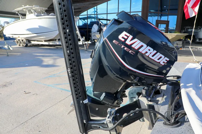 Slide: The Image of Outboard motor on Express 18 boat, 2019 model, in a marina setting. - 8