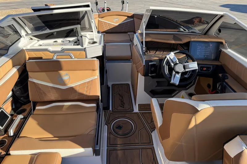 Slide: The Image of 2024 Tigé Ultré 23ZX boat interior with tan leather seats and modern dashboard. - 12